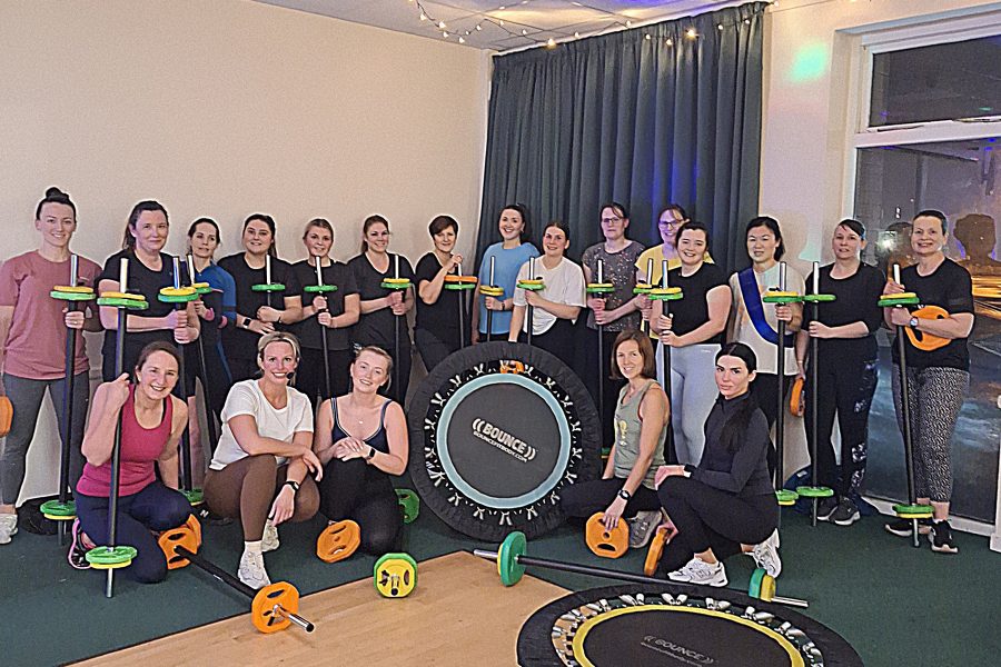 BOUNCE Fitness Logo and posed photograph of a group in a studio