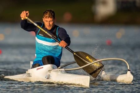 Logo of Poole Harbour Canoe club and photograph of Jack Eyers in Paracanoe racing