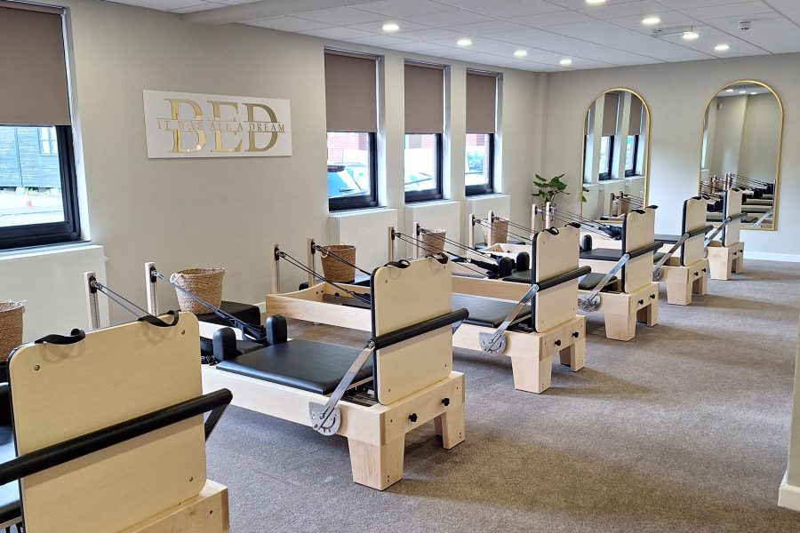 Bounce Bed Logo and picture of a studio with the exercise beds in it.