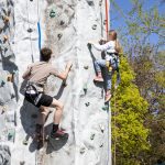 Instructor and child on the climbing tower at the sports and active leisure Festival